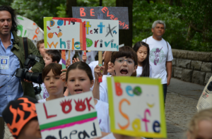 Calhoun School students march in memory of former classmate Cooper Stock, who was killed by a reckless cab driver last January. The students called themselves "Cooper's Troopers" and carried homemade signs highlighting safe driving. Photo by Daniel Fitzsimmons.